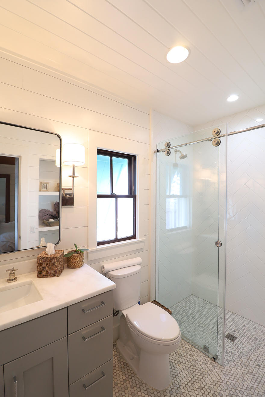 Cottage Two bathroom with shiplap walls, glass walk-in shower, and gray vanity