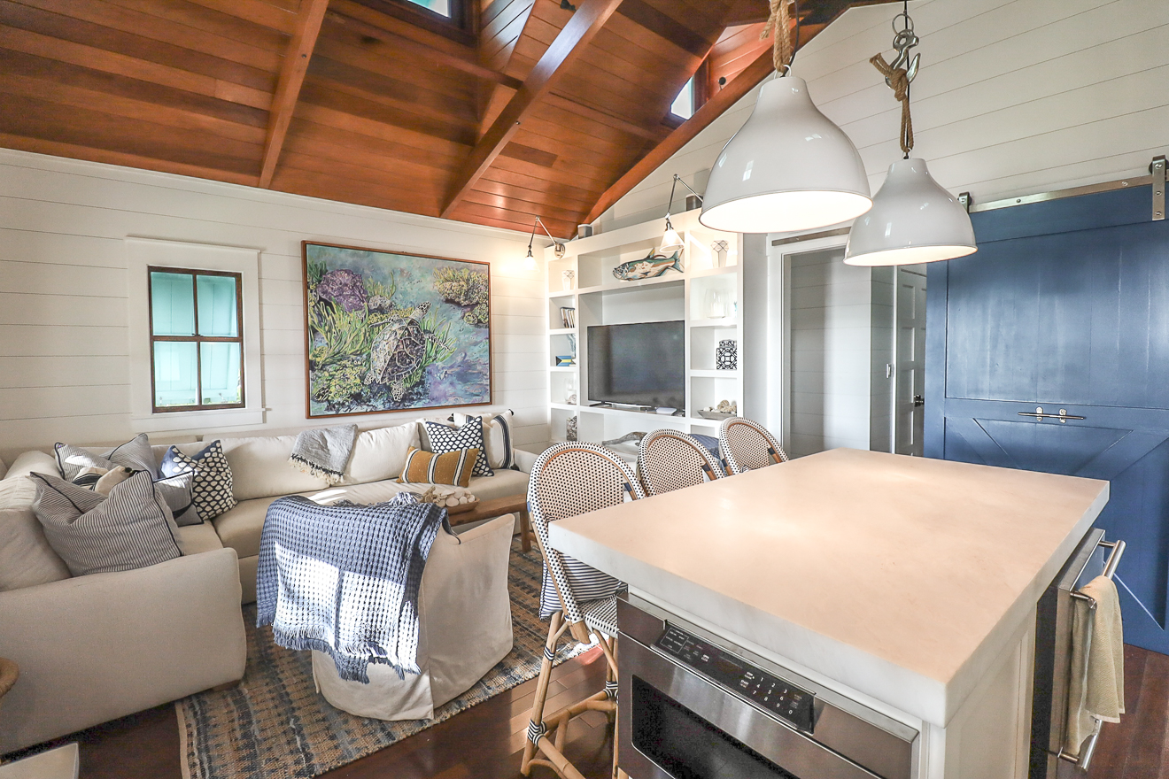 Open-plan kitchen and living area with cedar ceiling and kitchen island seating