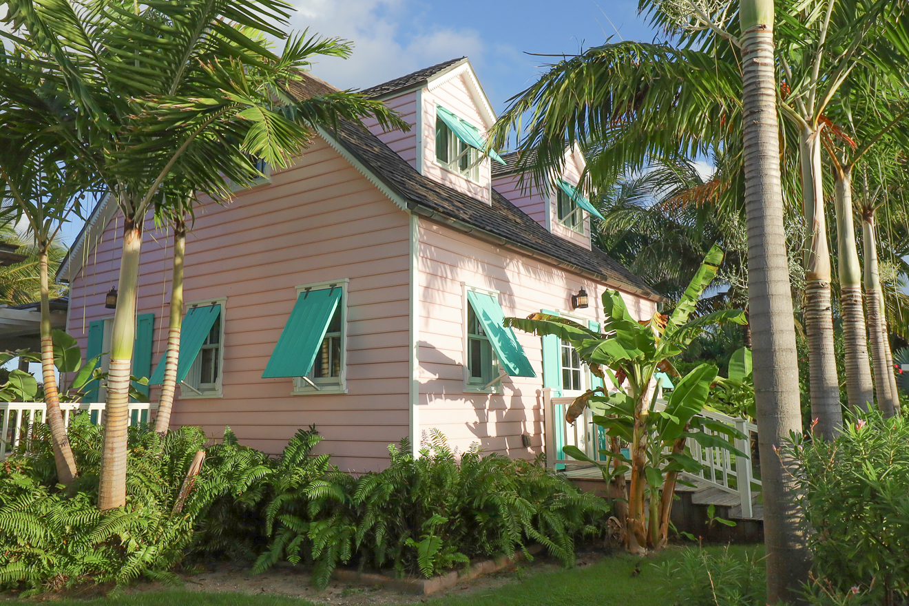 Side view of Cottage Two showing teal shutters and tropical palms